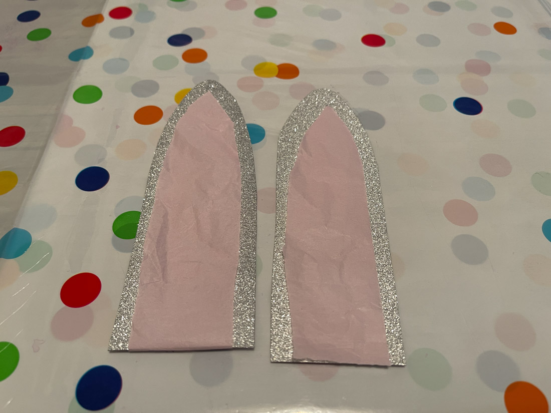Two bunny ears made from glitter card and pink tissue paper