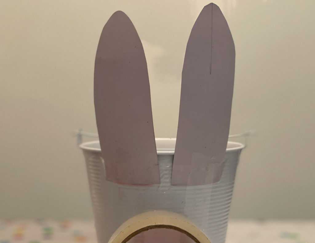 Bucket with bunny ears and roll of tape